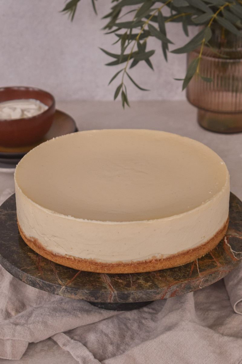 Rich and creamy classic cheesecake on a marble stand
