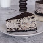 Slice of cookies and cream cheesecake with oreo crust