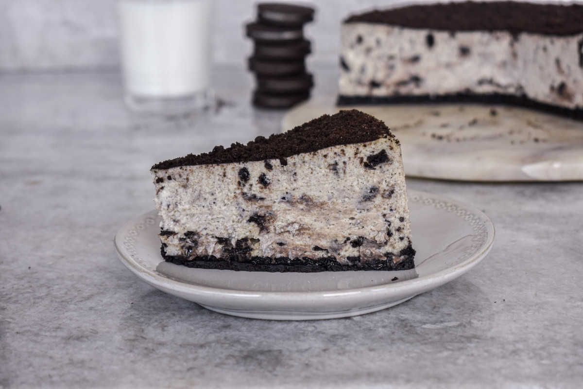 slice of cookies and cream cheesecake with milk and oreos