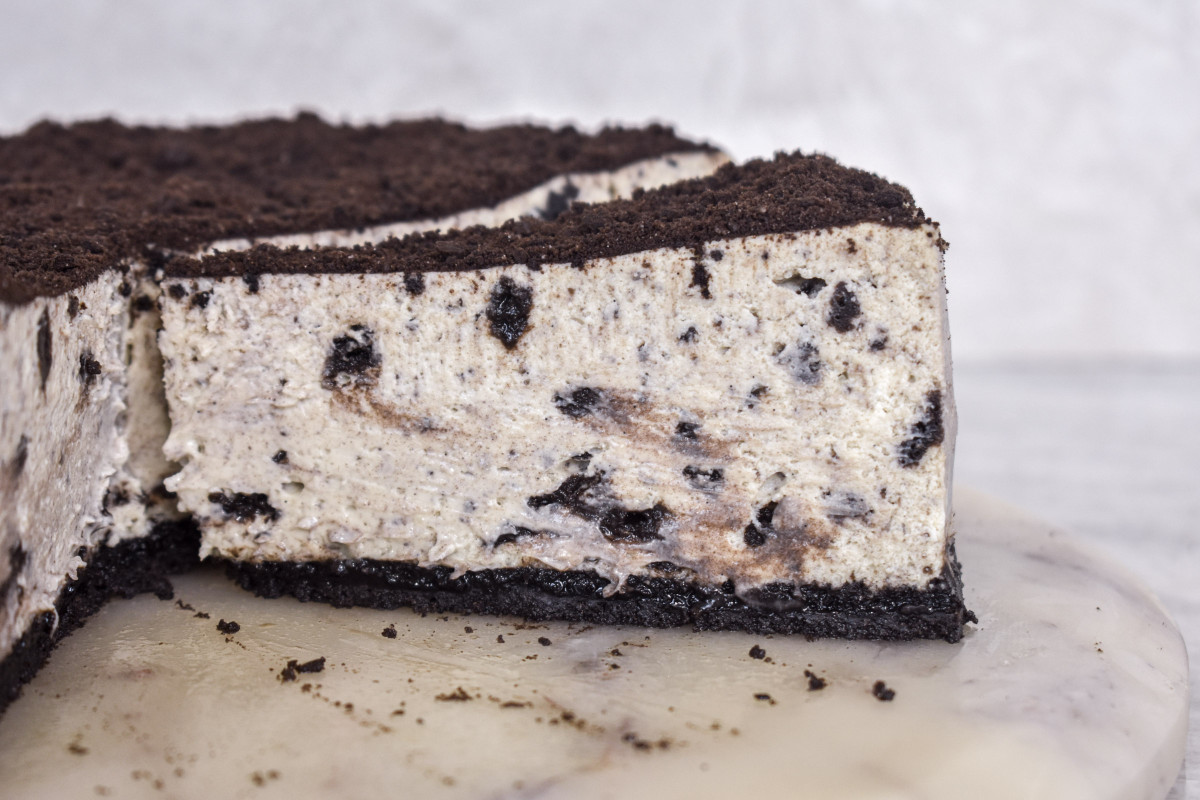 Cookies and cream cheesecake topped with whipped cream and Oreo cookies
